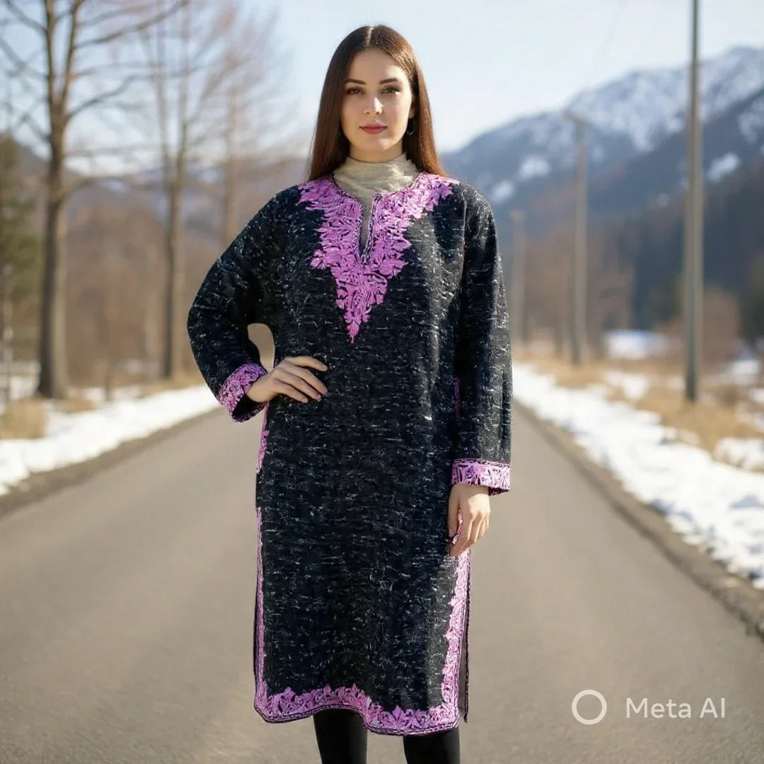Woman wearing black and purple embroidered winter pashmina shawl dress on a snowy mountain road