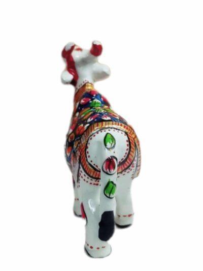 Hand-painted ceramic cow figurine with colorful floral patterns, from Zanskar Arts collection