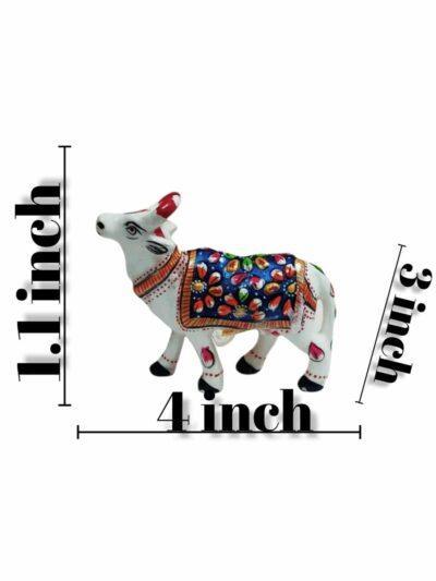 Hand-painted white ceramic cow figurine with colorful floral patterns, measuring 4x3x1.1 inches