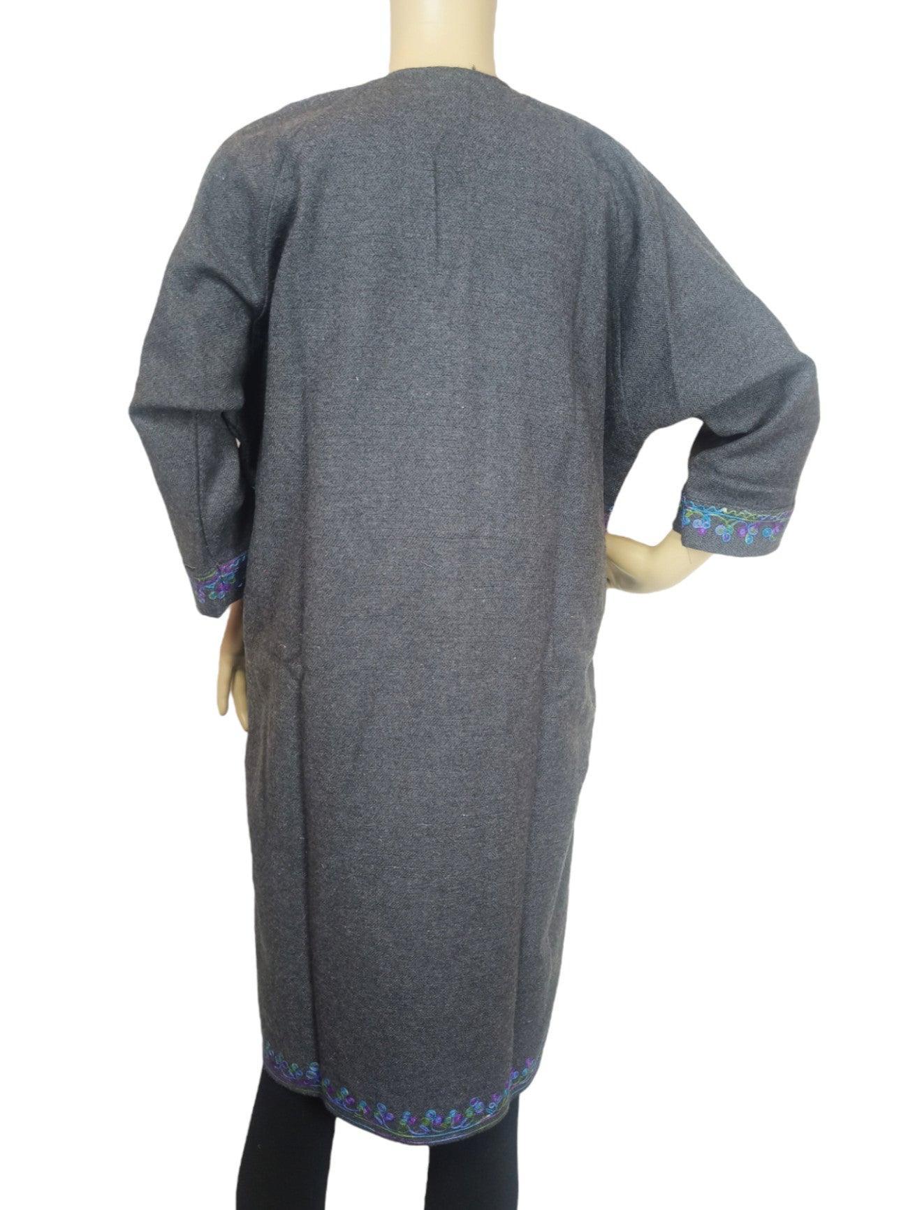 Back view of grey pashmina shawl dress with blue floral embroidery on cuffs and hem, worn on mannequin