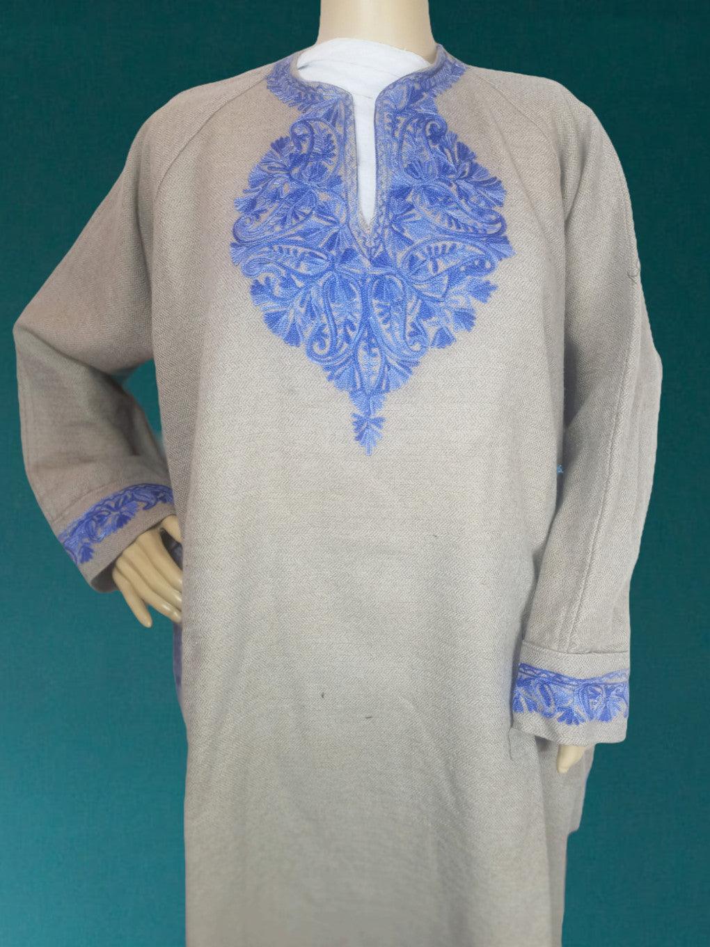 Traditional beige woolen kurta with intricate blue floral embroidery on neckline and cuffs, displayed on mannequin