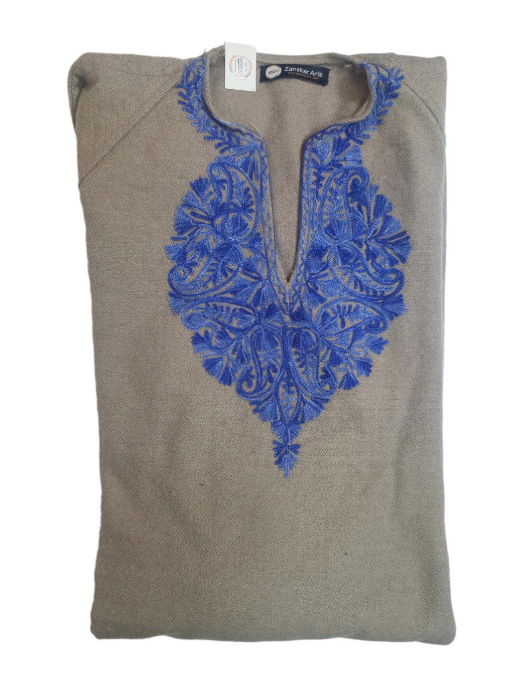 Folded beige Pashmina shawl with intricate blue embroidered floral pattern around neckline from Zanskar Arts