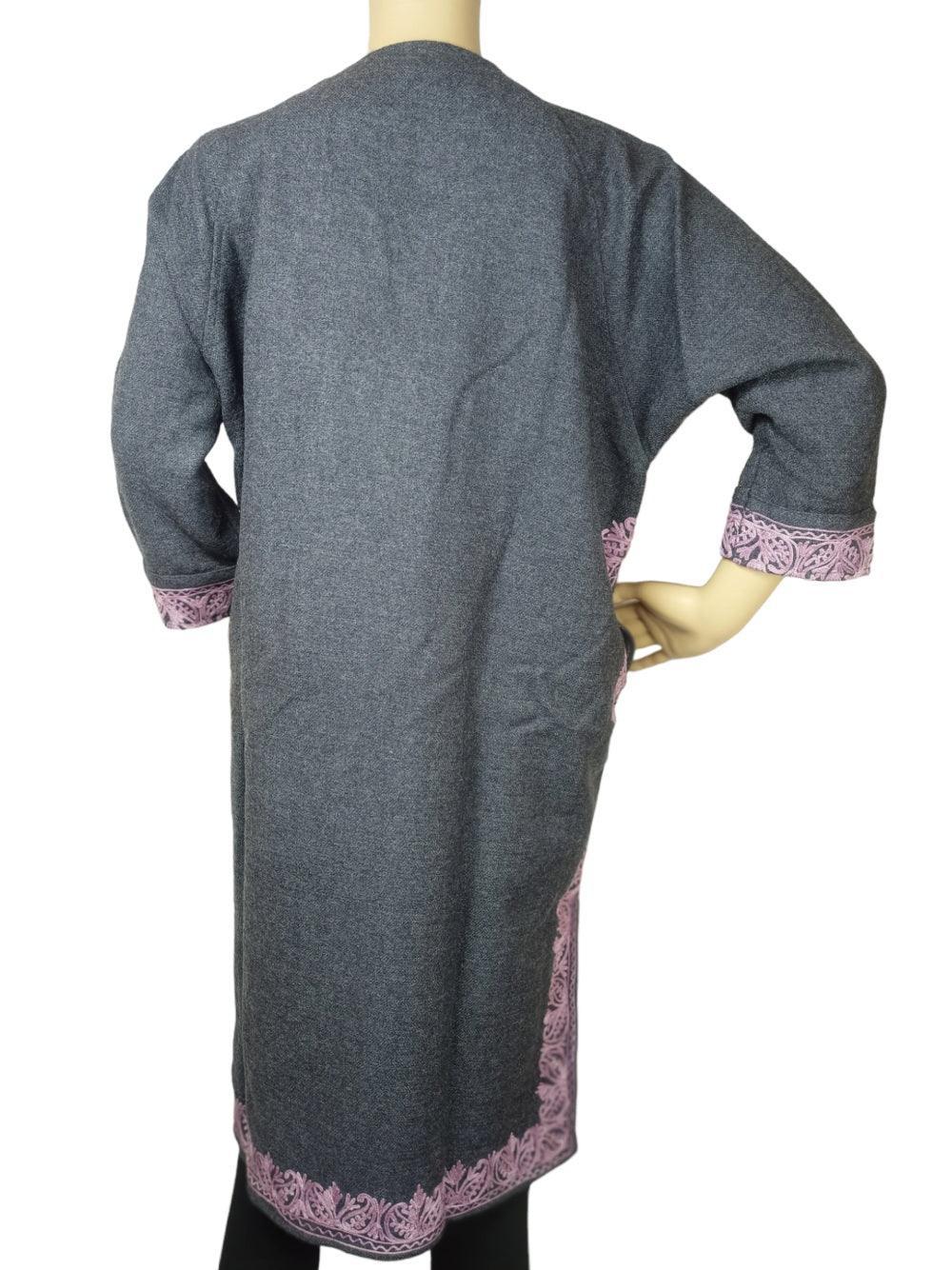 Back view of gray long woolen coat with pink embroidered cuffs and hem, displayed on mannequin