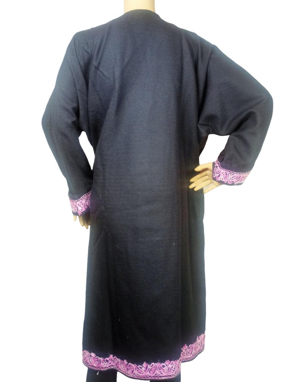 Black full-length wool coat with pink embroidered cuffs and hem, displayed on a mannequin