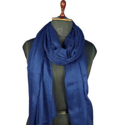 Elegant blue pashmina shawl draped on black mannequin, soft fabric from Zanskar Arts