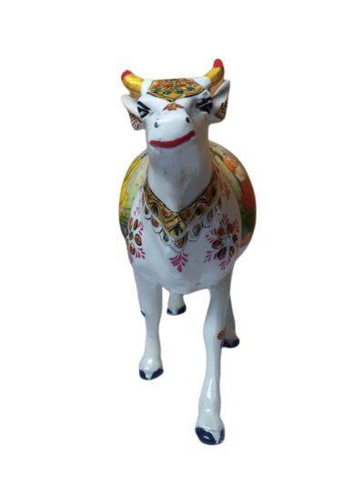 White metal decorative cow figurine with colorful floral and traditional patterns, handcrafted art piece