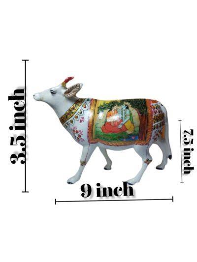White metal cow figurine with traditional paper mache art from Zanskar Arts, measuring 9x3.5x2.5 inches