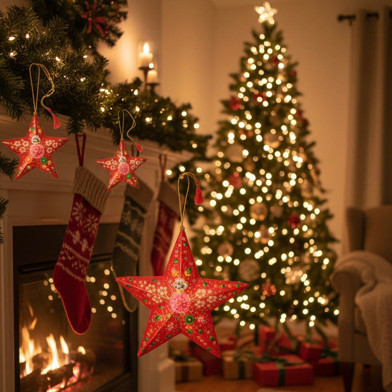 Cozy living room with lit fireplace, hanging red star ornaments, stockings, and decorated Christmas tree