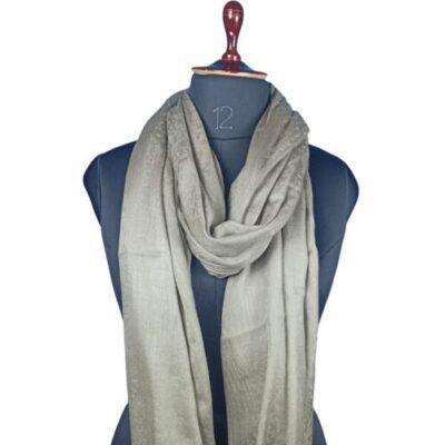 Elegant light beige Pashmina shawl draped on a blue mannequin, showcased by Zanskar Arts